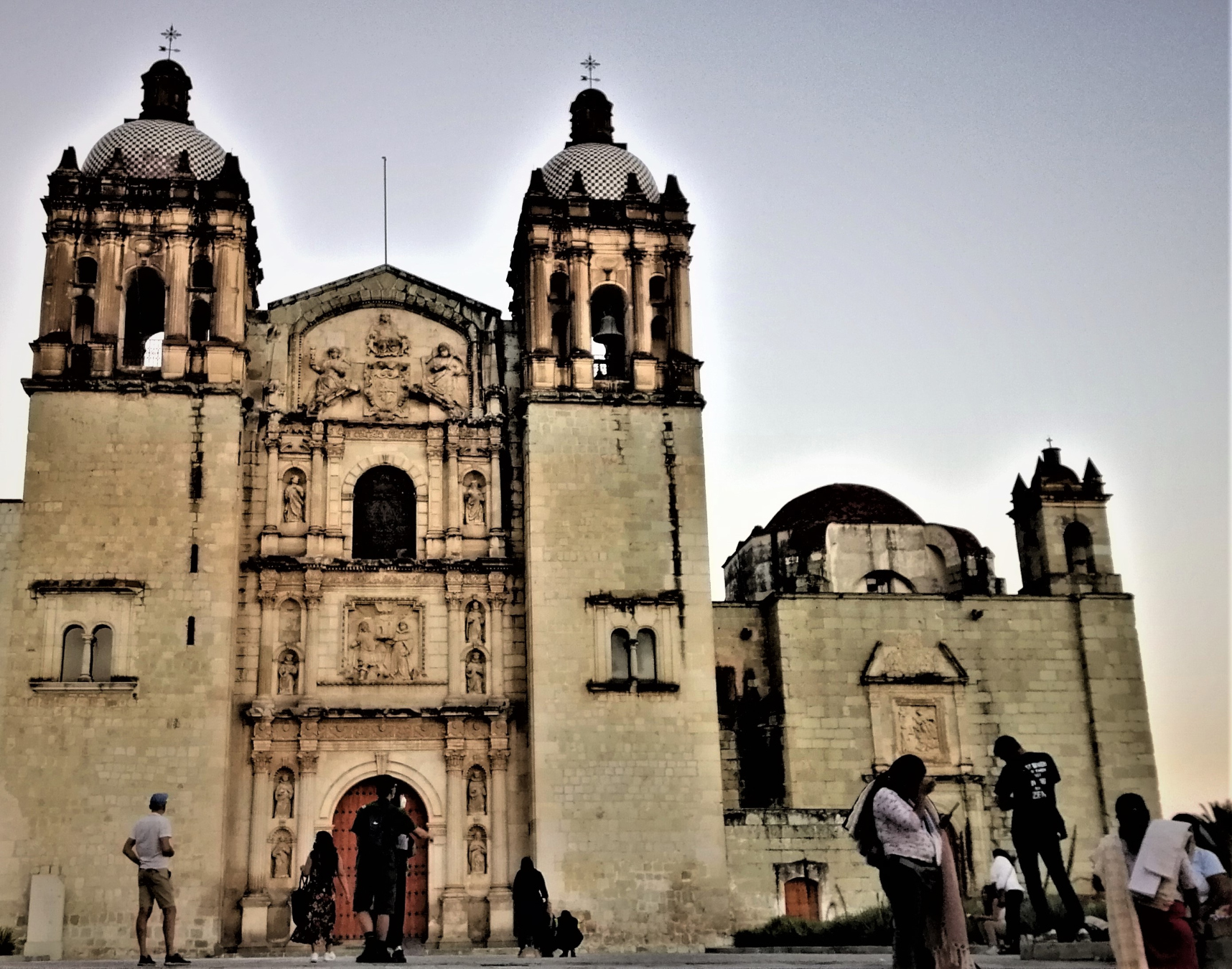 A rustic church and people in Oaxaca City, Mexico.