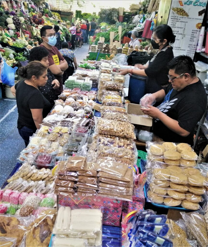 Consumers, vendors, sweets, and abundant veggies in the mercado central.  From the post: Guatemala City: A Terrific Travel Destination. 