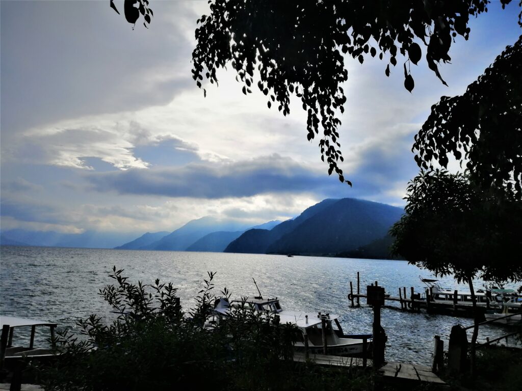 View of a cloudy sky and cascading mountains behind Lake Atitlán, Panajachel Guatemala. From the Post: Refurbished Former US School Buses: The Pulse of a Nation
