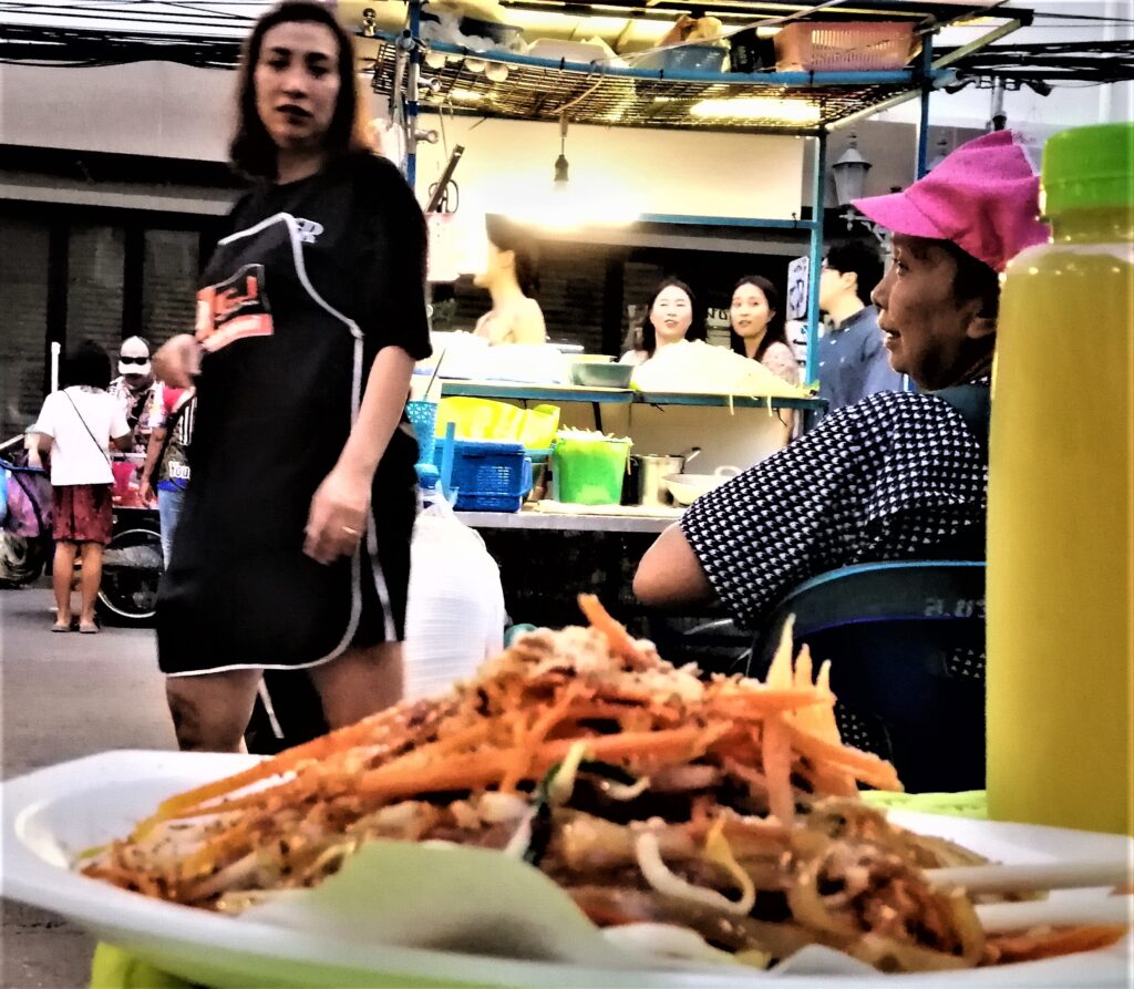 Ubiquitous street eats, hawkers and walkers outside at night in Thailand's steamy capital. From the post: Wiped Out After A Journey Across the Earth.