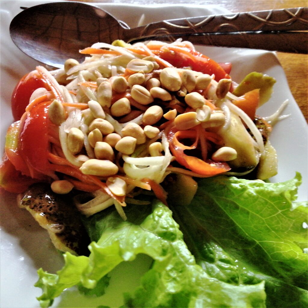 Cuisine papaya salad with peanuts loaded on top. From the post: Luang Namtha: Why I Spent a Week in a Virtual Ghost Town.