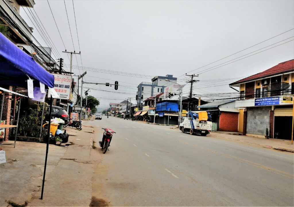 A virtually empty road under gray skies early in the day in northern Laos.  From the post: Luang Namtha: Why I Spent a Week in a Virtual Ghost Town.