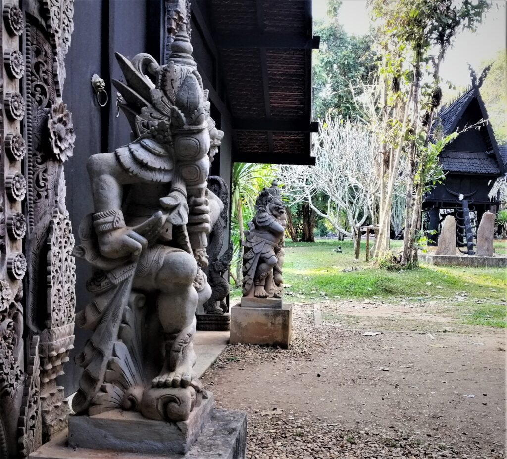 Detailed statues, outdoors, grass, trees, Thai Lanna architecture.  In the post: Temple Drifting and Coffee Sipping in Chiang Rai.