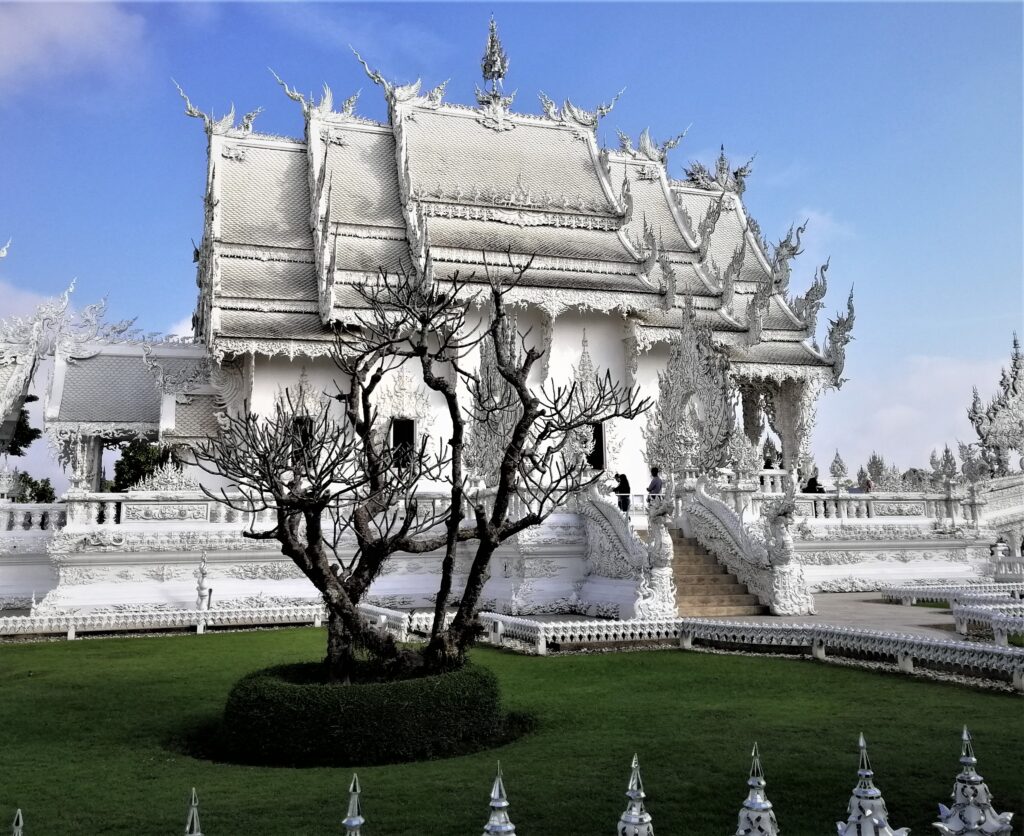 And incredible side view of the White Temple under a mostly blue morning sky.