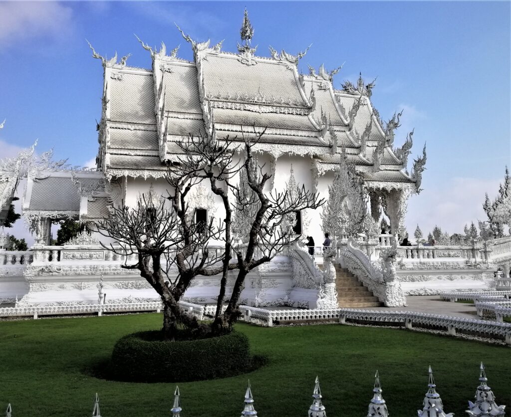 And incredible side view of the White Temple under a mostly blue morning sky. In the post: Temple Drifting and Coffee Sipping in Chiang Rai.