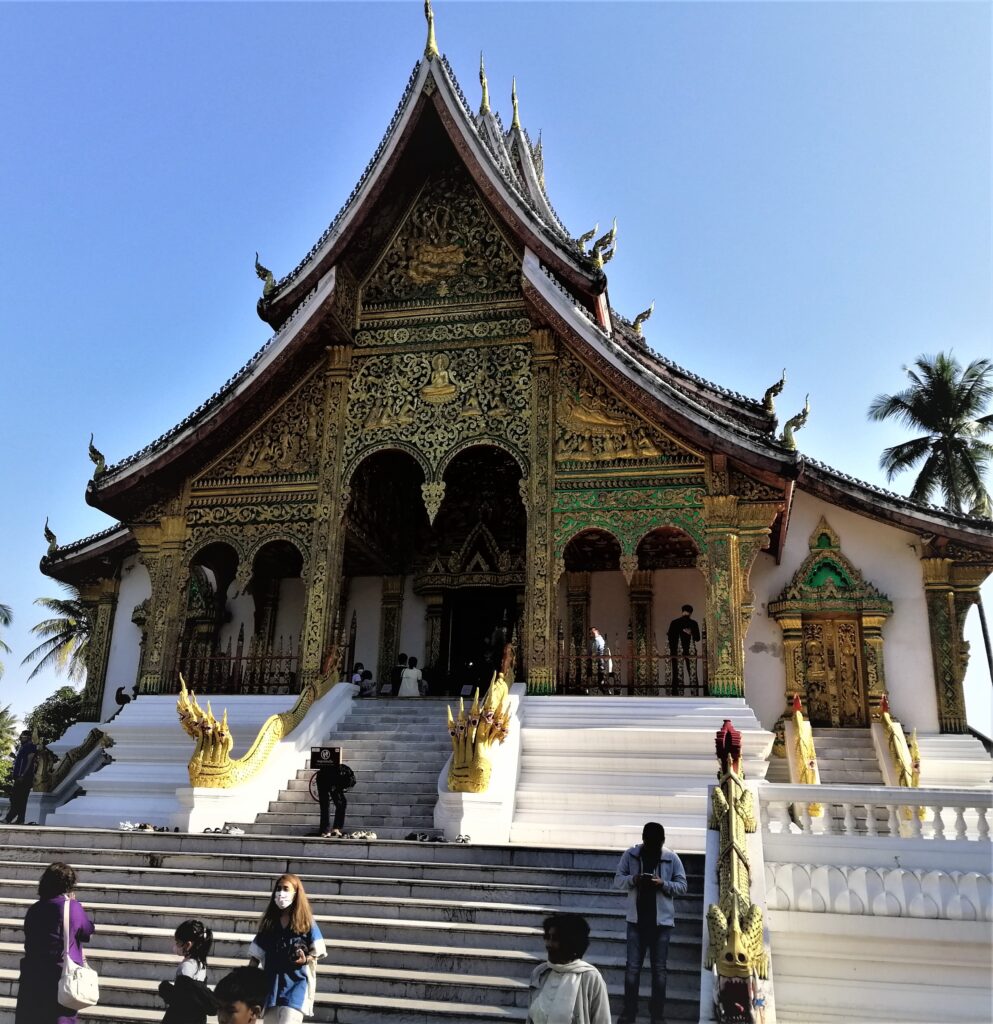 A huge intricate temple with steps and people leading to the exotic façade. In the post: Infinite Earth Art: Temples of Luang Prabang.