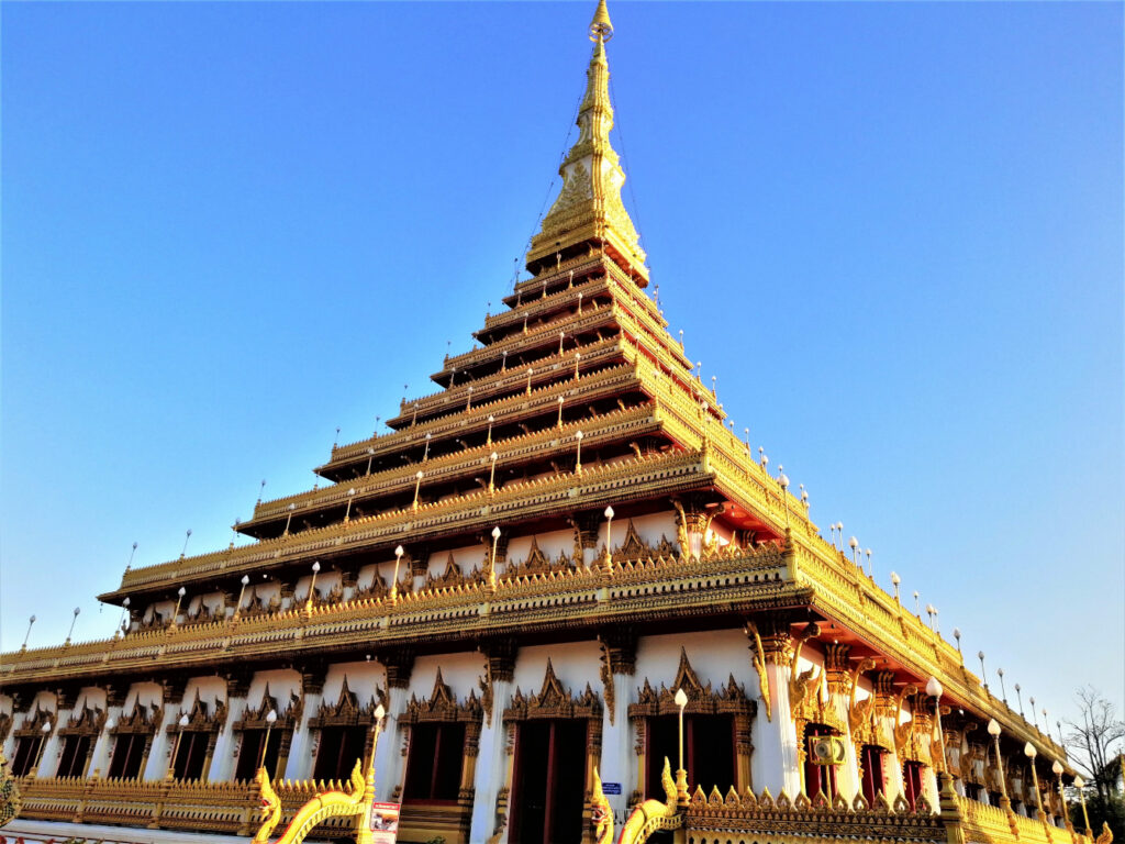 A pretty padoda pyramid style temple under a pure blue sky. In post: Khon Kaen: A City of Unknown Wonders.