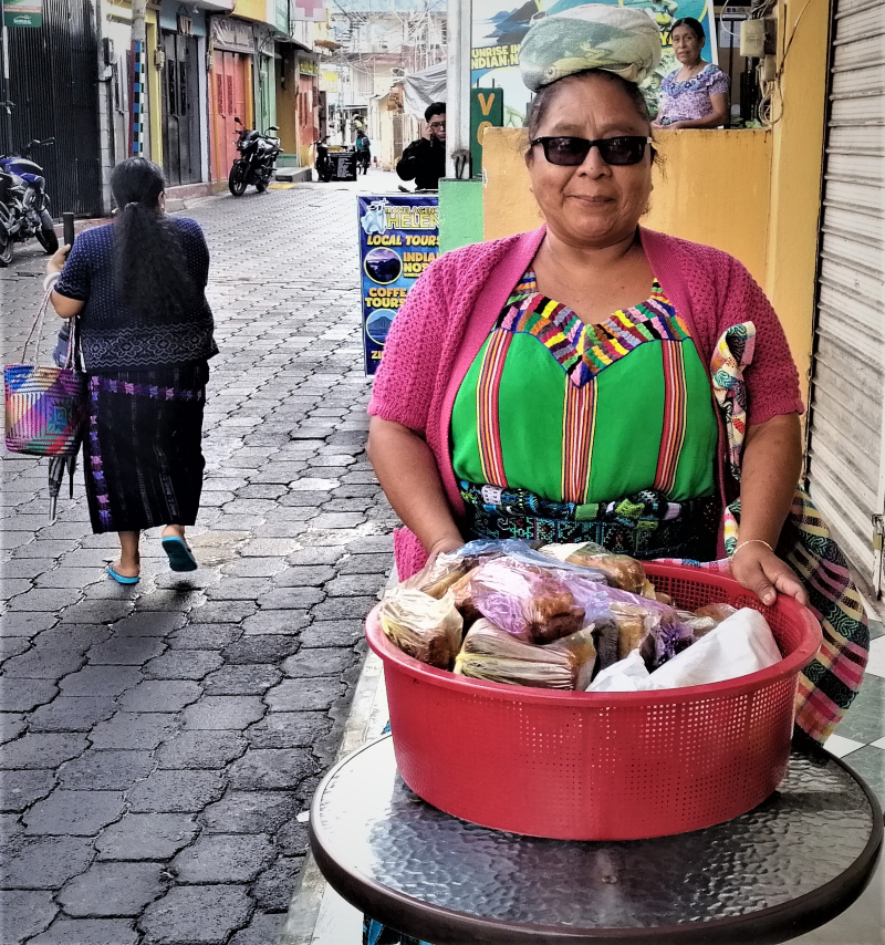 A hawker sells freshly baked breads in San Pedro la Laguna on Lago Atitlán, Guatemala.