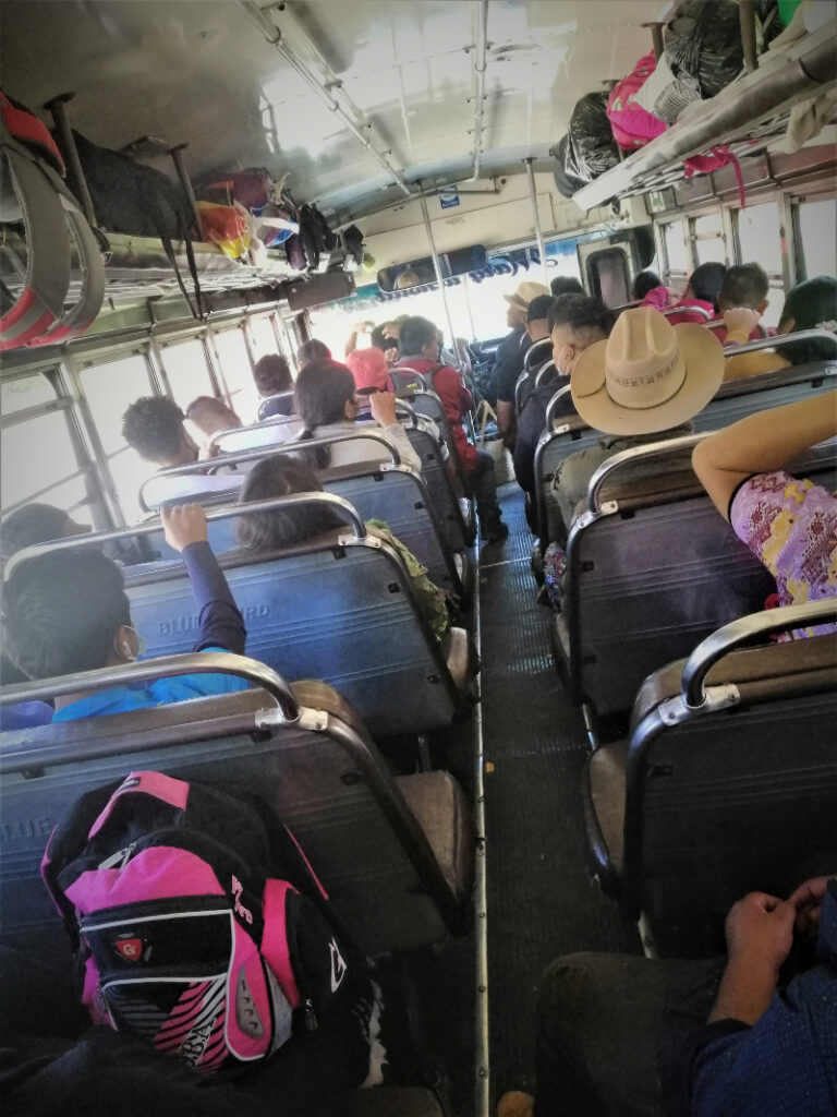 People and baggage on a bus bound for Los Encuentros from Chimaltenango, Guatemala.