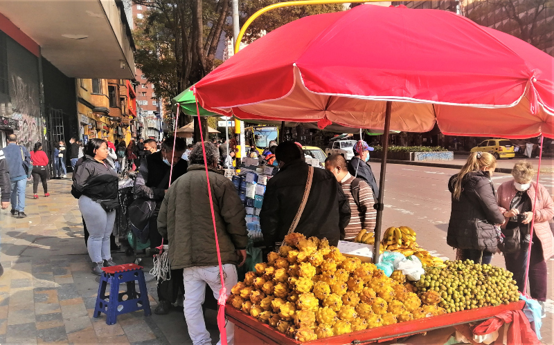 Colombian travel tips a street cart selling pitaya -dragon fruit- outside on a busy street Colombia's capital city of Bogotá. 