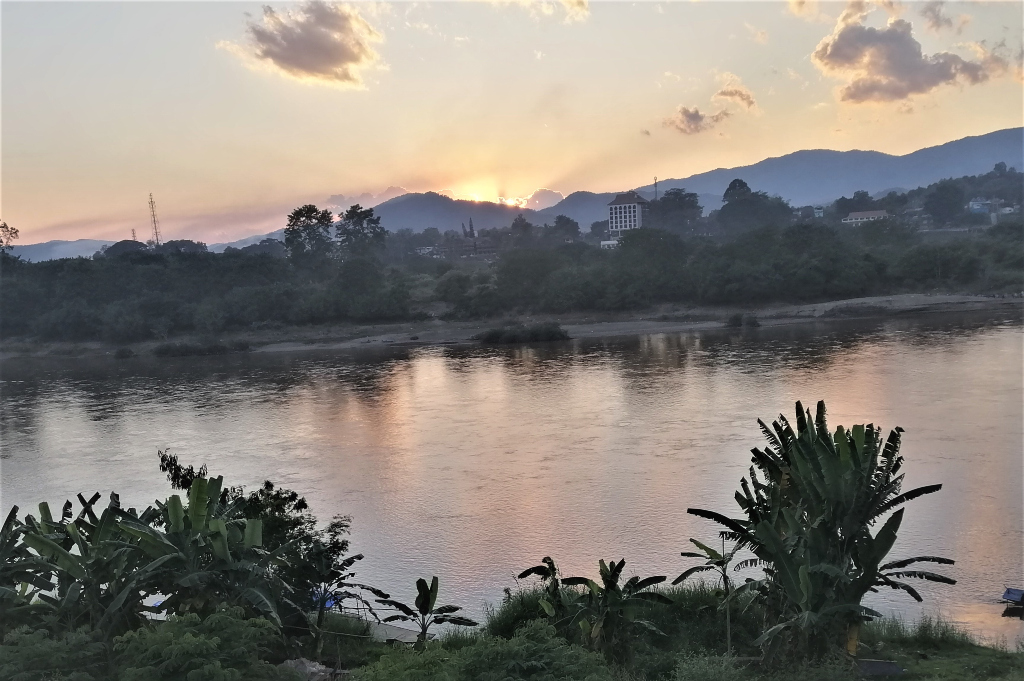 Sunrise behind the Mekong River in Chiang Kong, Thailand from Huay Xai, Laos.
