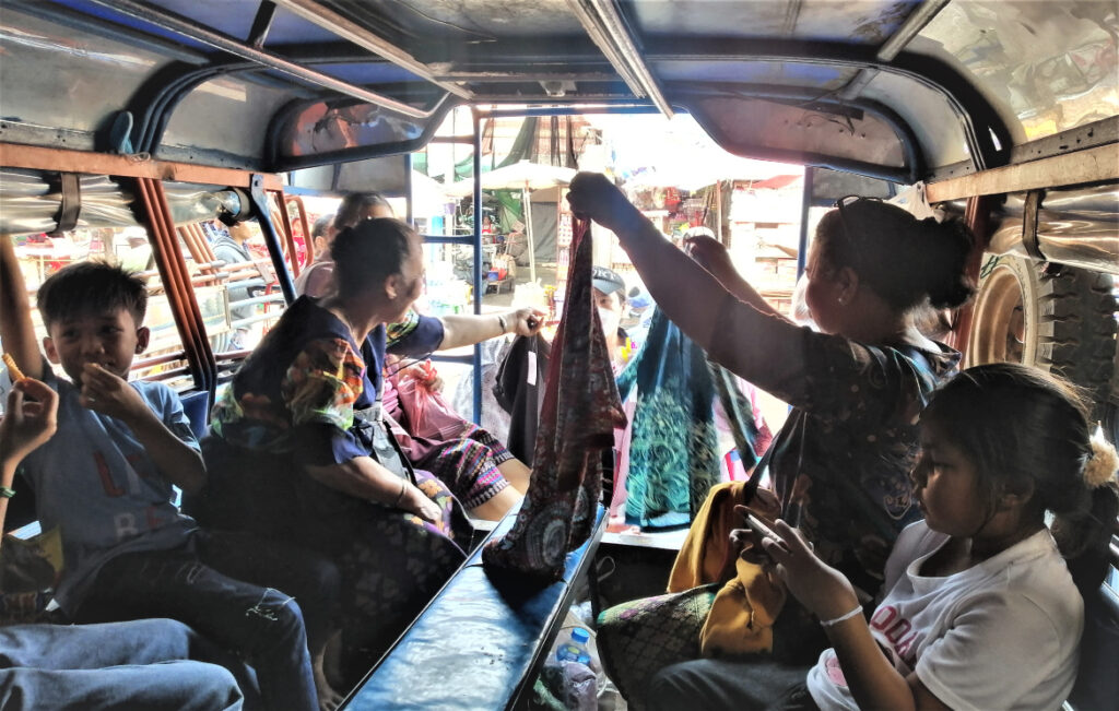 Local southern Lao people wait on a songtaew at Dao Hueang Market in Pakse, and bound for Champasak. In Post: Khmer Hindu Time Travel at the Ruins of Vat Phu.