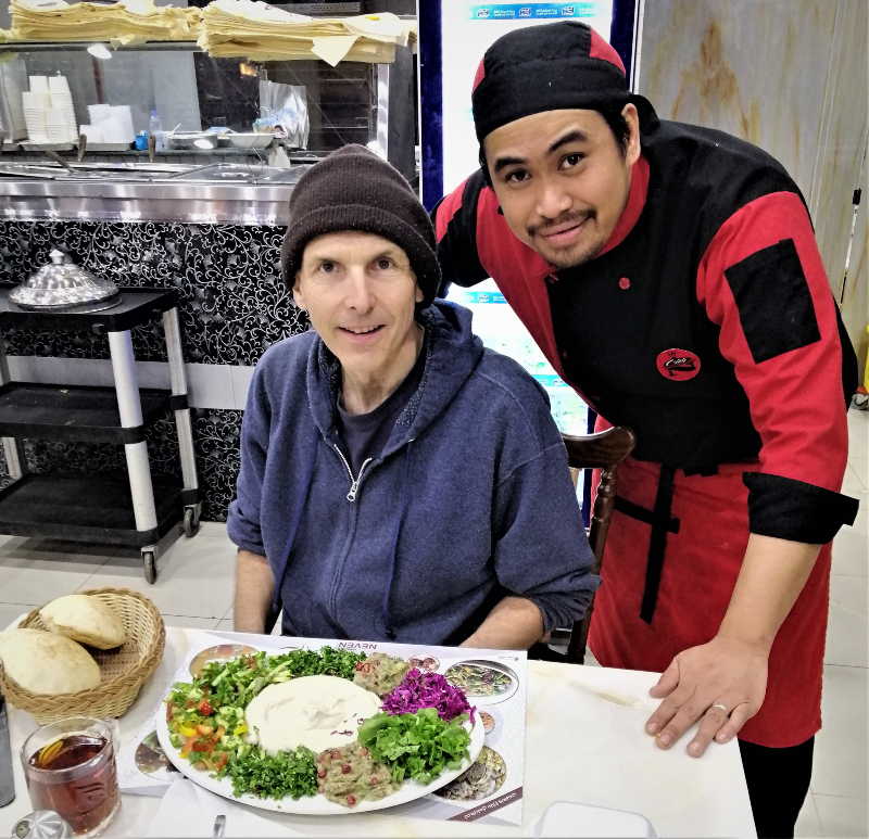 Me, the chef and a huge plate of vegan raw vegan Turkish food at Neven Turkish Restaurant in Hafr al-Batin, Saudi Arabia.