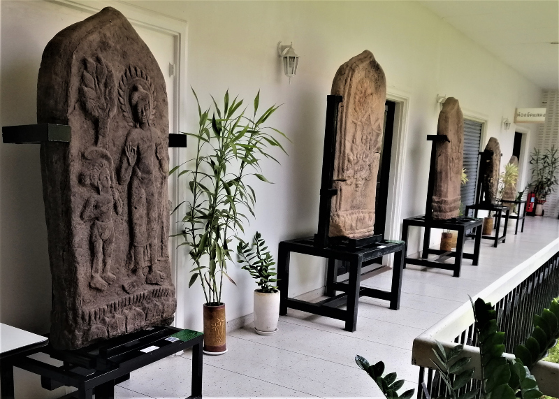 Five huge bounty stones in a row outside, along a courtyard wall. In post: Visiting The Khon Kaen National Museum.