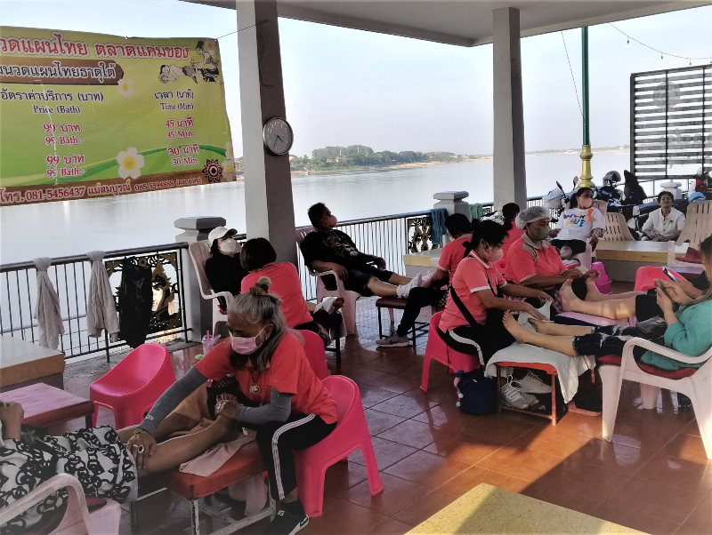 A thriving outdoor massage parlor on the Mekong River in Nong Khai, northeastern Thailand.  Across the river you can see Laos.