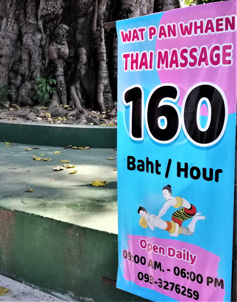 Sign: Thai Massage Offer at Wat Pan Whaen along with a nice massage depiction.