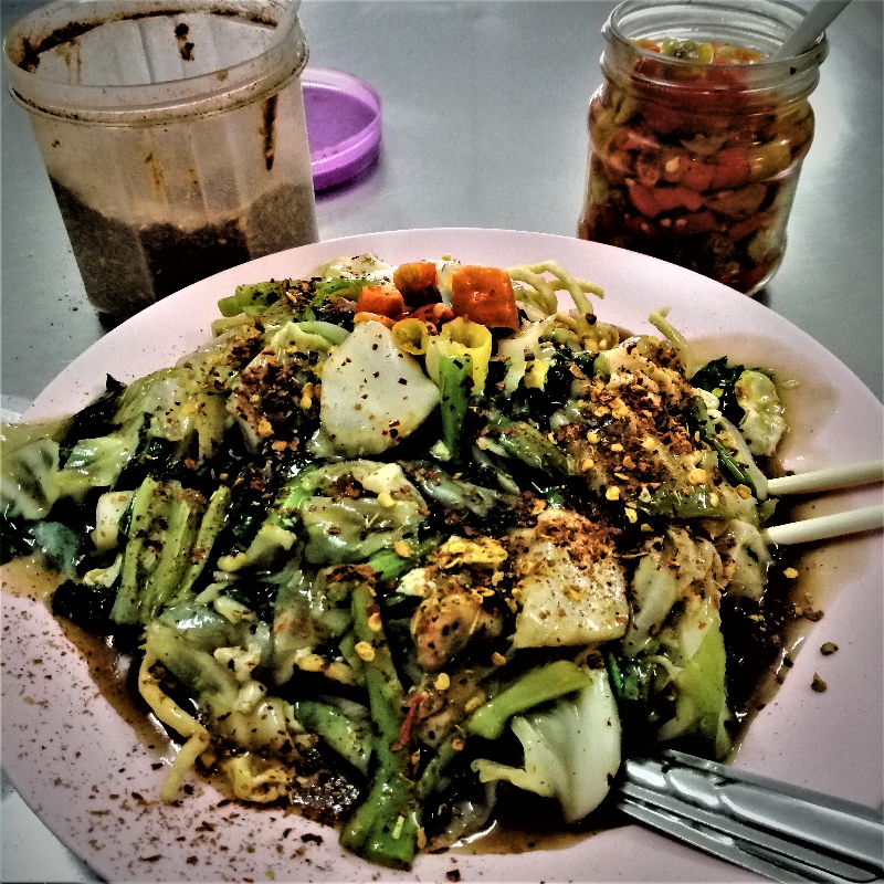 Delicious spicy Chinese-style food in a downtown Vientiane eatery.  Crispy noodles with vegetables and then topped with two forms of chili pepper.  Yum!