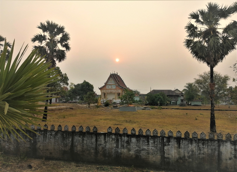 A temple under a dim, dry-season, dusk sky in Champasak, southern Laos.