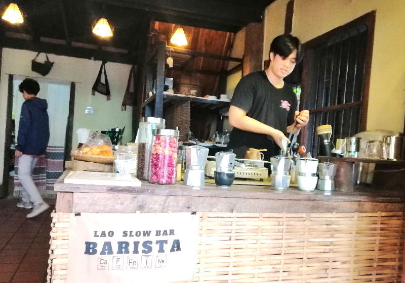 Coffee barista in action inside 'Lao Lo' café, Luang Prabang, Laos.