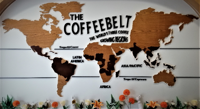 World wall map showing the coffeebelt, the earth's three coffee growing regions, all of which are between the Tropic of Cancer and the Tropic of Capricorn.