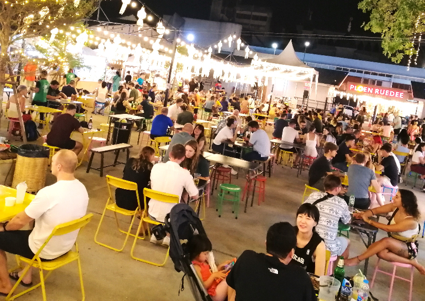 Night market filled with foreigners sitting and eating, Chiang Mai, Thailand.