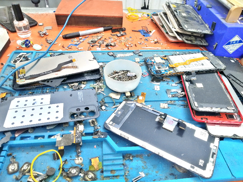 Work bench with lots of phone parts inside Thanh Nhan Mobile, Ho Chi Min City, Vietnam.
